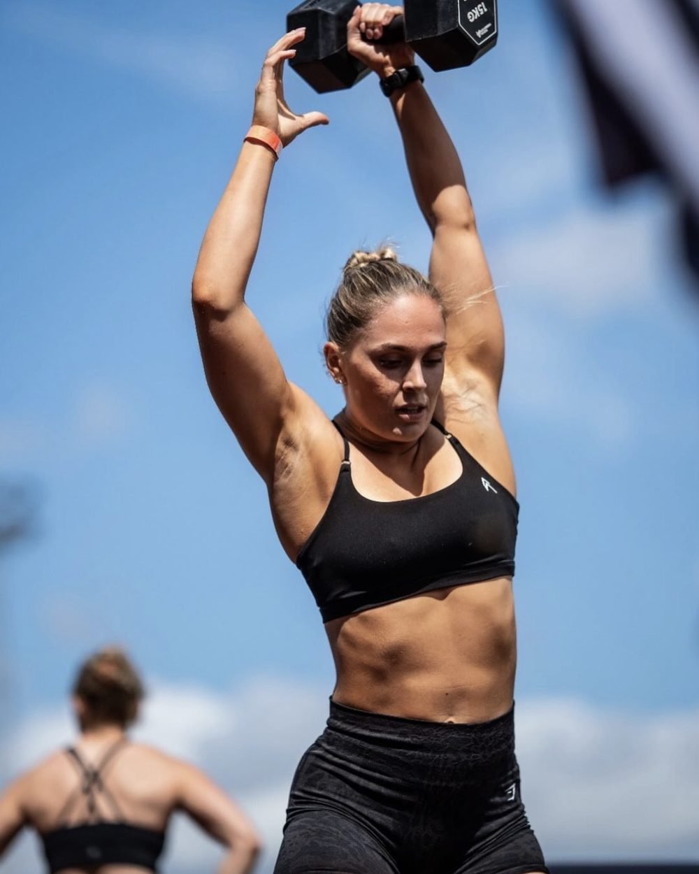 Niamh Broad lifting a dumbbell overhead in training